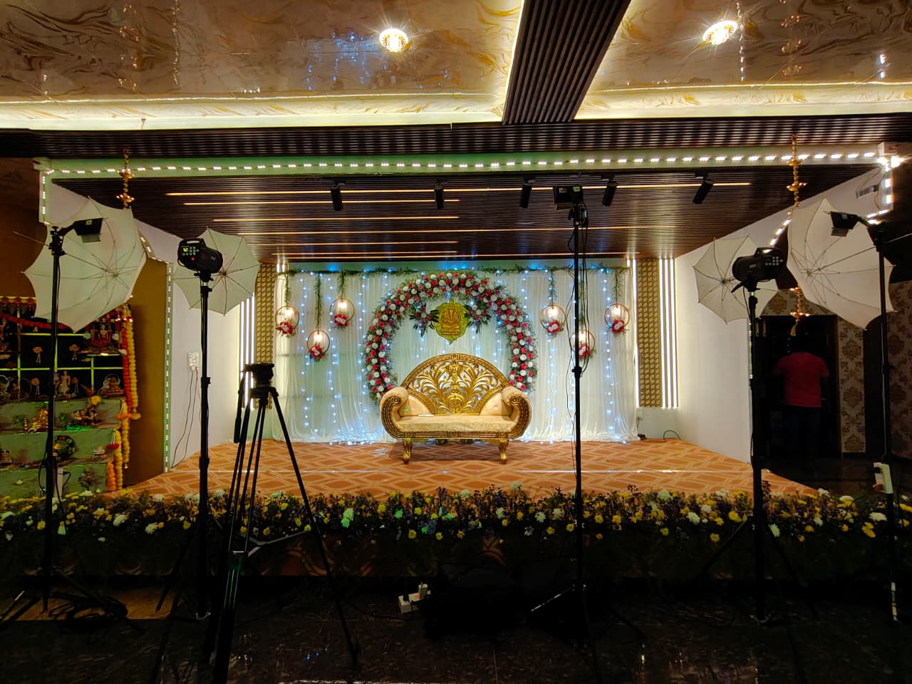 Decorated wedding stage with floral arch at Adithi Paradise convention hall in Tiruttani